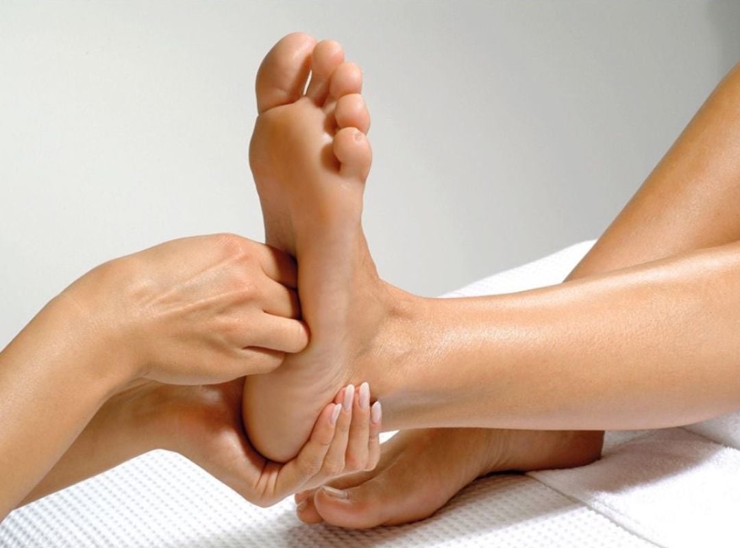 Therapist performing foot massage to relieve tension and improve circulation at DC Chiropractic Markham