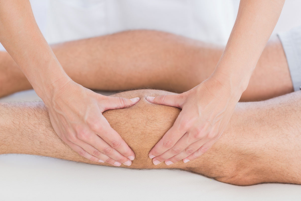 Physiotherapist performing knee therapy during a physiotherapy session at DC Chiropractic Markham