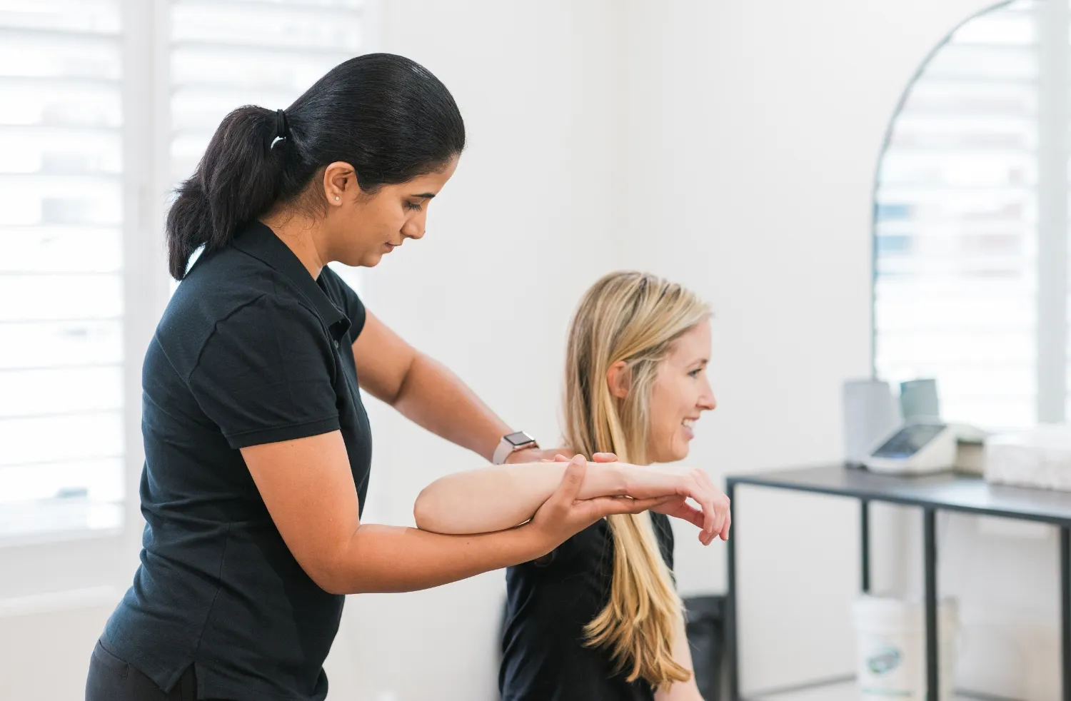 Physiotherapist assessing shoulder and arm movement during physiotherapy treatment at DC Chiropractic Markham