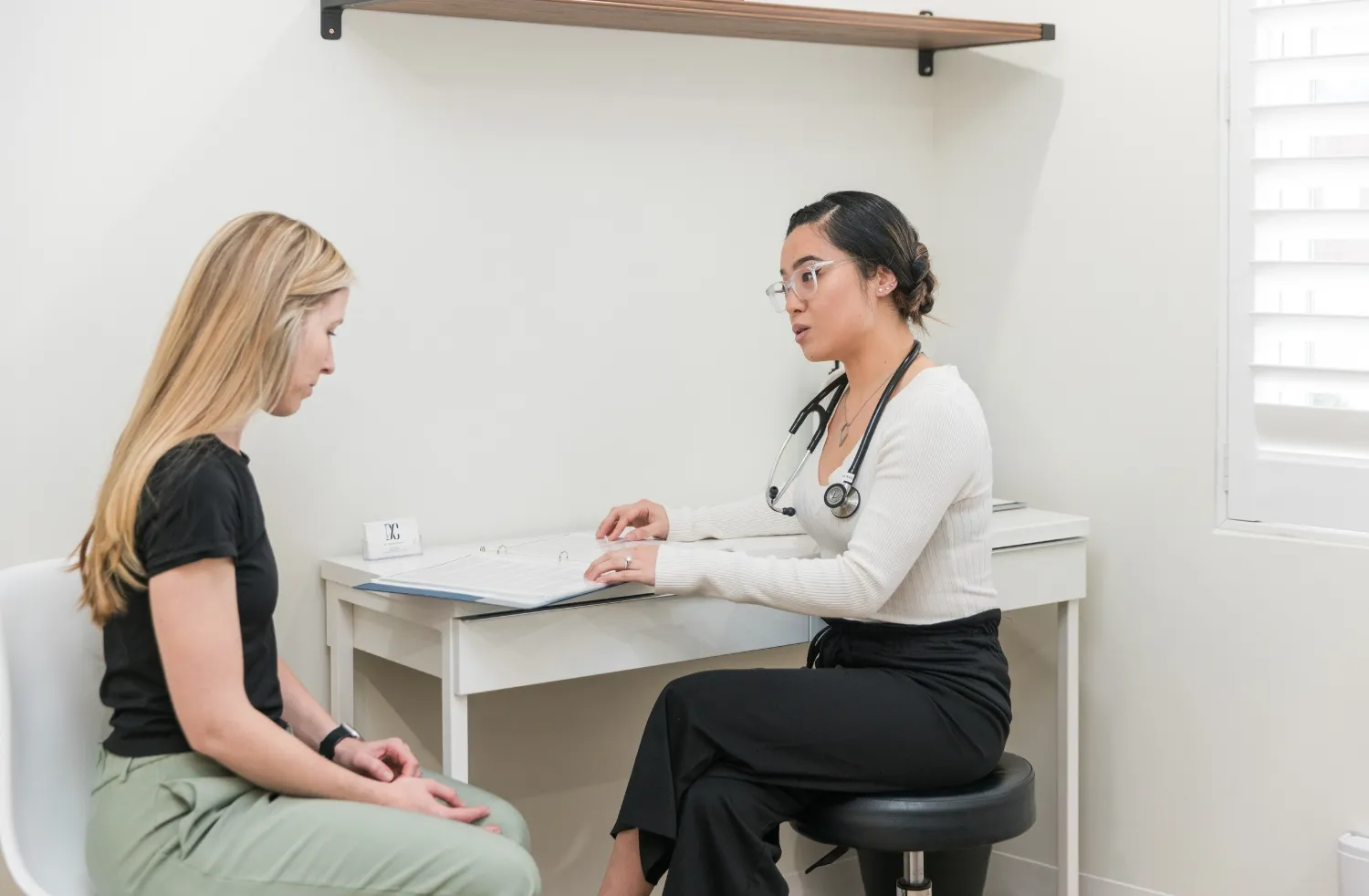 Patient consulting with a healthcare professional during a treatment planning session at DC Chiropractic Markham